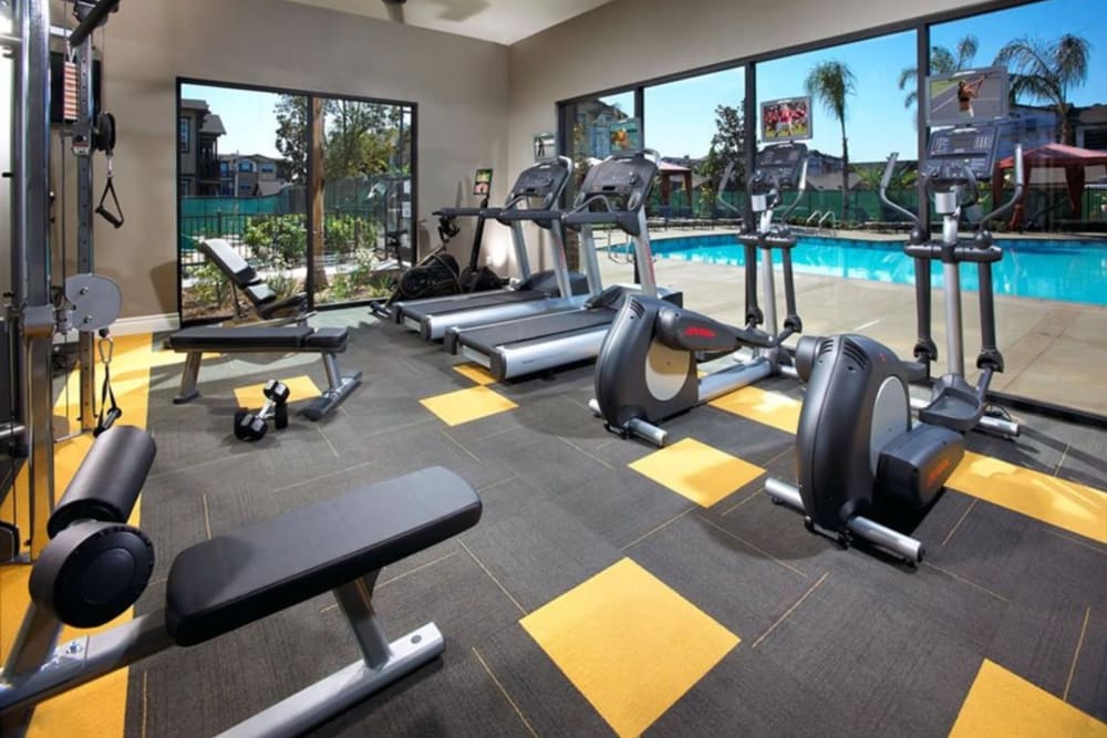 Large fitness room with modern workout equipment at Artisan at East Village Apartments in Oxnard, California