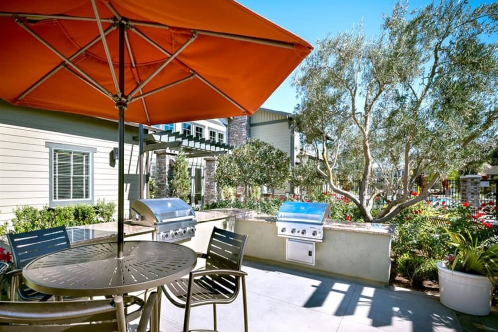 Patio seating and in-ground pool at Artisan at East Village Apartments in Oxnard, California