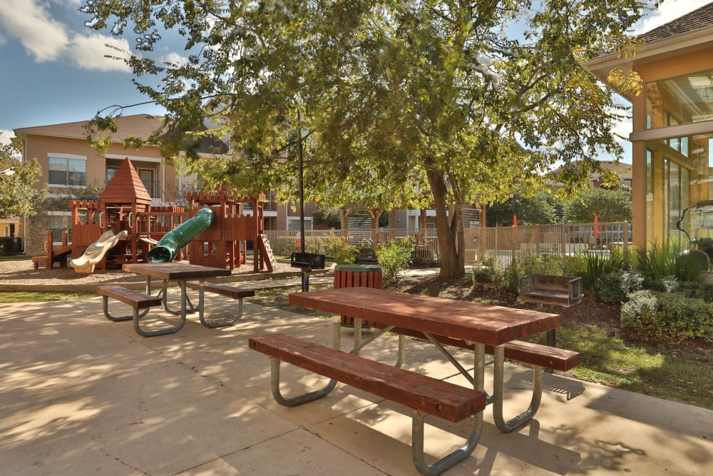 A shaded sitting area by the children's playground at Cypress Creek at River Bend in Georgetown, Texas