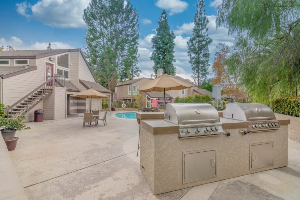 Outdoor grills by the pool at Canyon Crest Views Apartments in Riverside, California