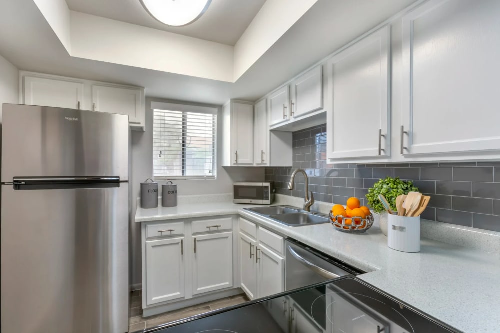 Beautiful kitchen with modern amenities and plenty of lighting at Newport in Avondale, Arizona