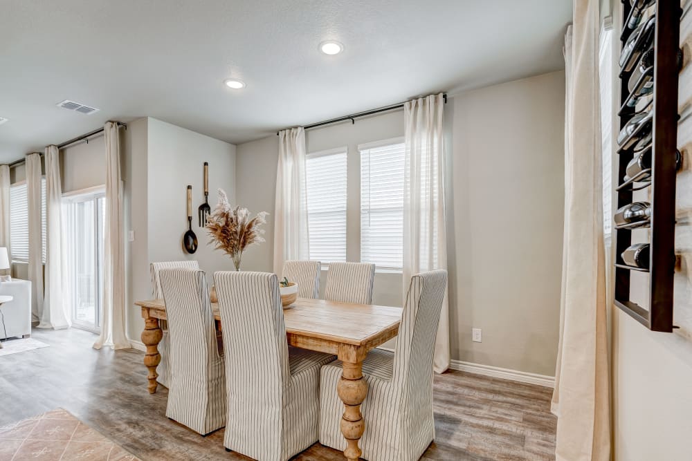 Nice dining area with wood-style flooring at BB Living Harvest in Argyle, Texas