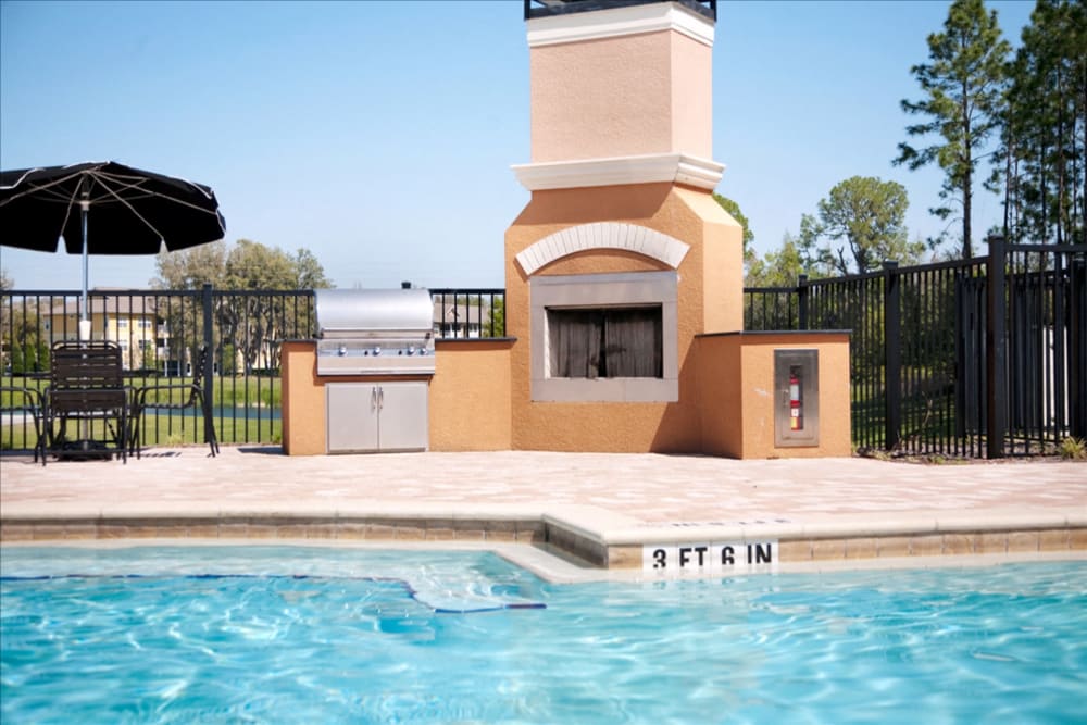 Swimming pool and outdoor fireplace at The Columns at Cypress Point in Wesley Chapel, Florida
