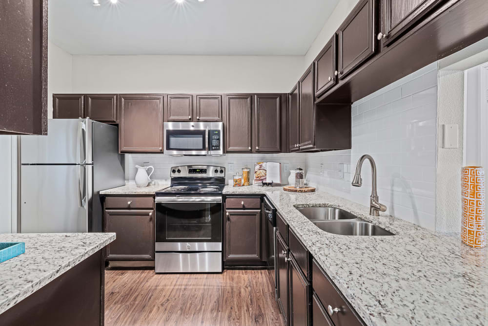 Kitchen with granite counters at Marquis at Ladera Vista in Austin, Texas 