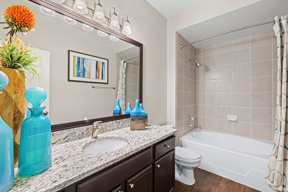  Spacious bathroom with Granite Countertops and upgraded lighting fixtures at Marquis at Ladera Vista in Austin, Texas