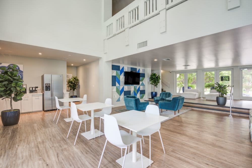 Large community room with open glass doors and flat screen TV at The Villas at Woodland Hills in Woodland Hills, California 