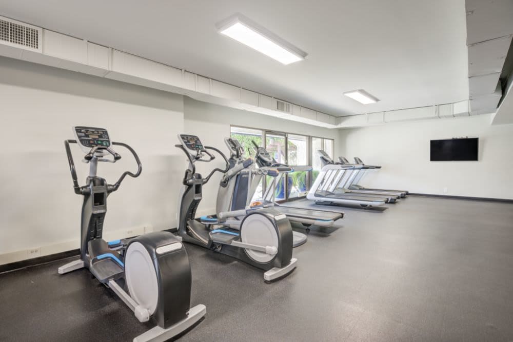 Open cardio area in the fitness center with various fitness machines at The Villas at Woodland Hills in Woodland Hills, California 