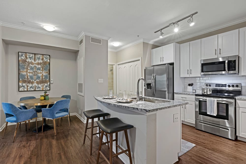 Kitchen with Stainless-Steel Appliances and dining room atMarquis Parkside in Austin, Texas
