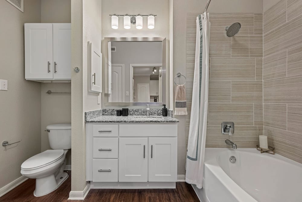 Apartment bathroom with Upgraded Lighting Fixtures atMarquis Parkside in Austin, Texas