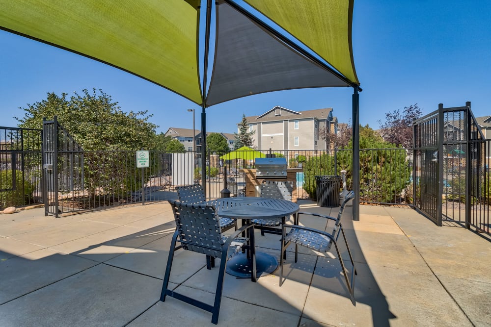 Grilling station with sunshade, table and chairs at Reserve at South Creek in Englewood, Colorado