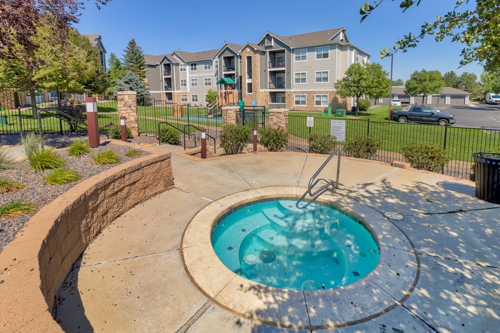 Community buildings in background and outdoor spa pool at Reserve at South Creek in Englewood, Colorado