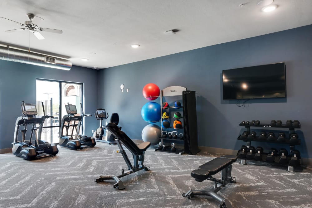 Community fitness area with dumbbells, Stairmasters, and more at Discovery Park in Denton, Texas