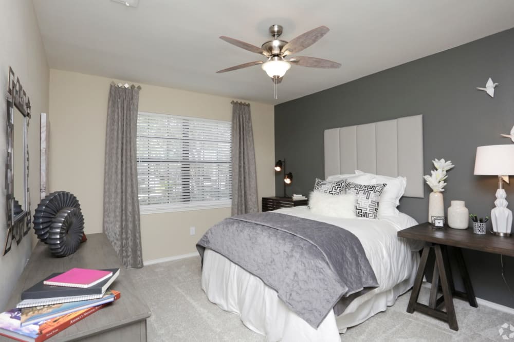 Model bedroom with large window at The Columns at Westchase in Houston, Texas