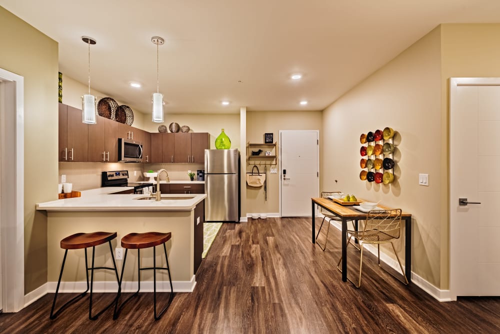 Kitchen with counter seating at Cosmopolitan Apartments in Pittsburgh, Pennsylvania