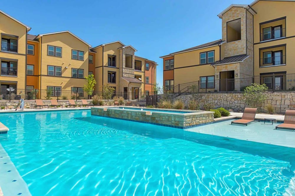 Sparkling community pool with lounge seating at Latigo at Eagle Pass in Eagle Pass, Texas