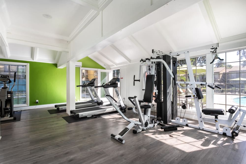 Large exercise room with various workout equipment at Sierra Vista Apartments in Redlands, California