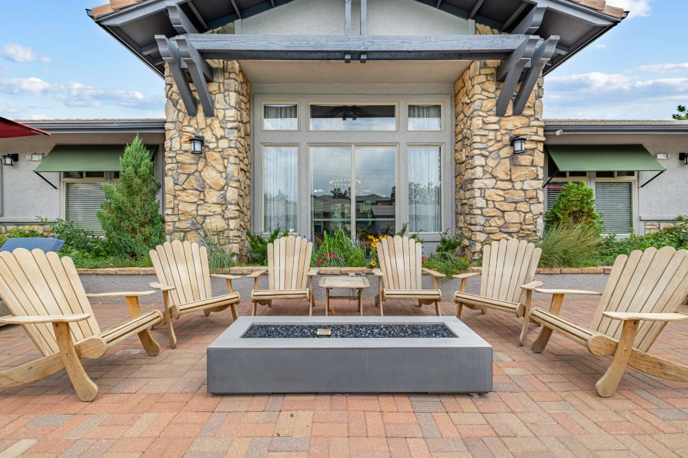 Poolside tables with umbrellas at Montrachet Apartment Homes in Lakewood, Colorado
