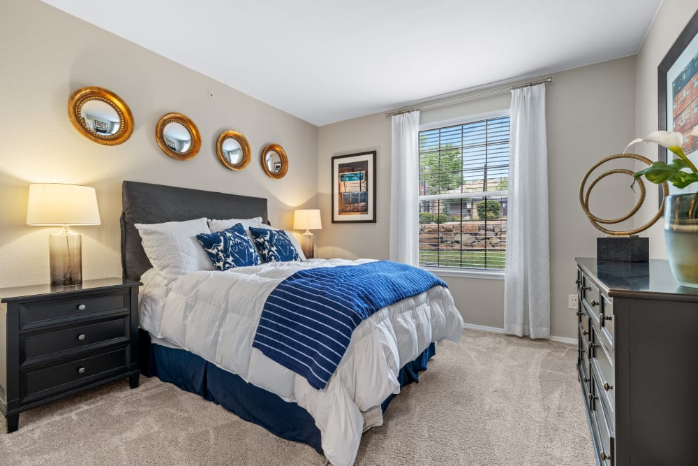 Model bedroom with plush carpets at Montrachet Apartment Homes in Lakewood, Colorado