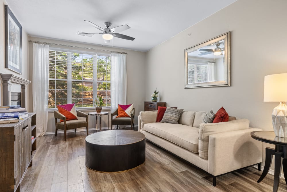 Spacious living room with a ceiling fan and hardwood floors at Montrachet Apartment Homes in Lakewood, Colorado
