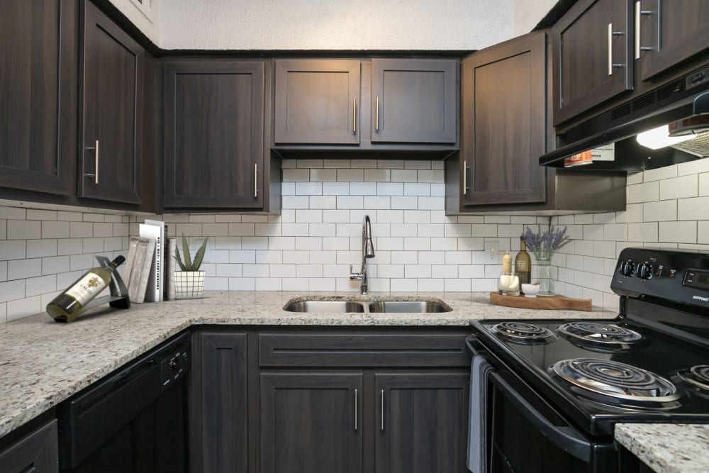 Kitchen with dark cabinetry and appliances at Magnolia Place Apartments in Franklin, Tennessee