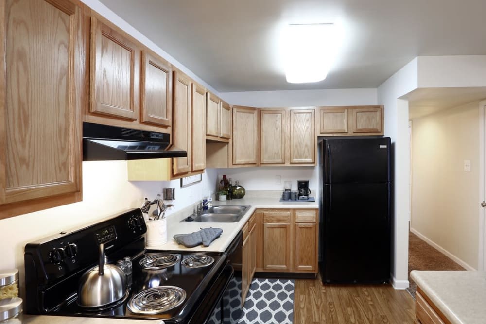 Kitchen with wood-style flooring at Brookwood Apartments, Indianapolis, Indiana