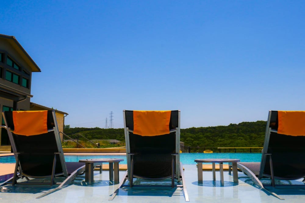 Lounge chairs next to the pool at The View at Crown Ridge in San Antonio, Texas