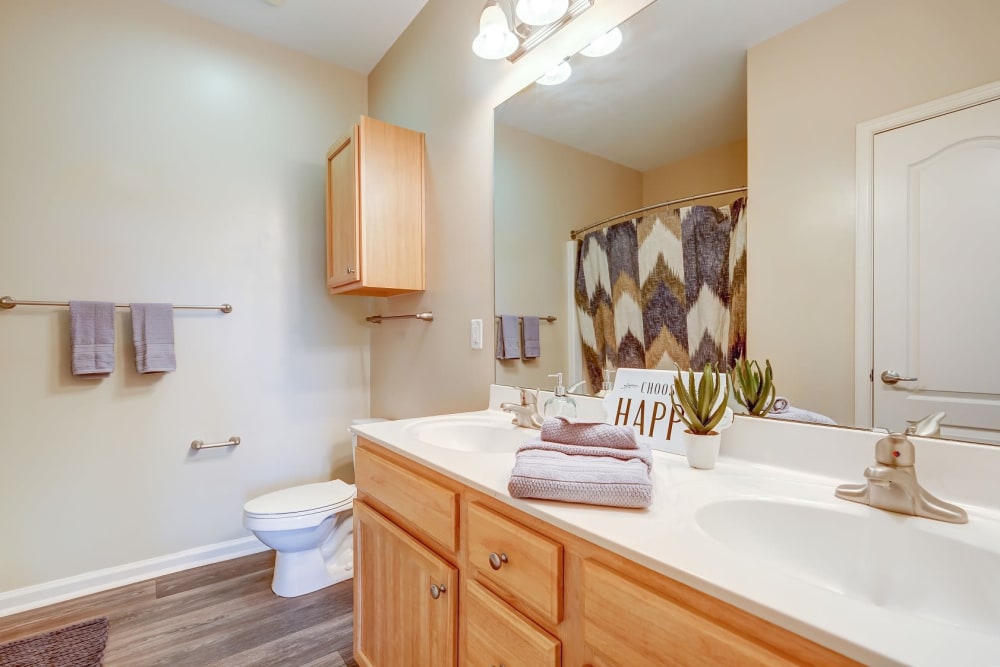 Bathroom with wood cabinets at Carden Place Apartment Homes