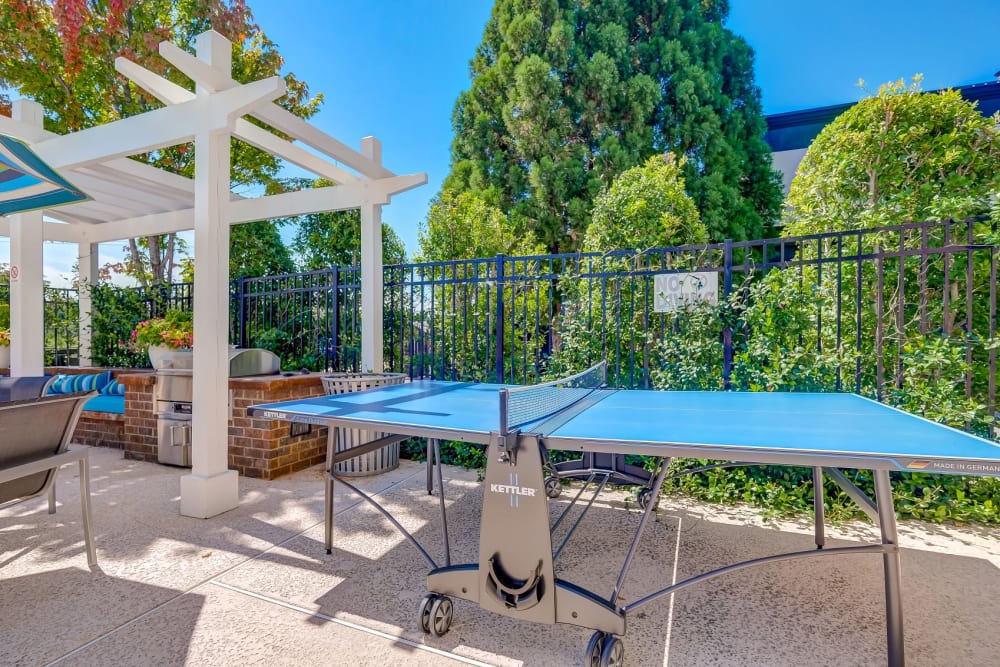 Poolside lounge with ping pong table at Reserve at Kenton Place Apartment Homes in Cornelius, North Carolina