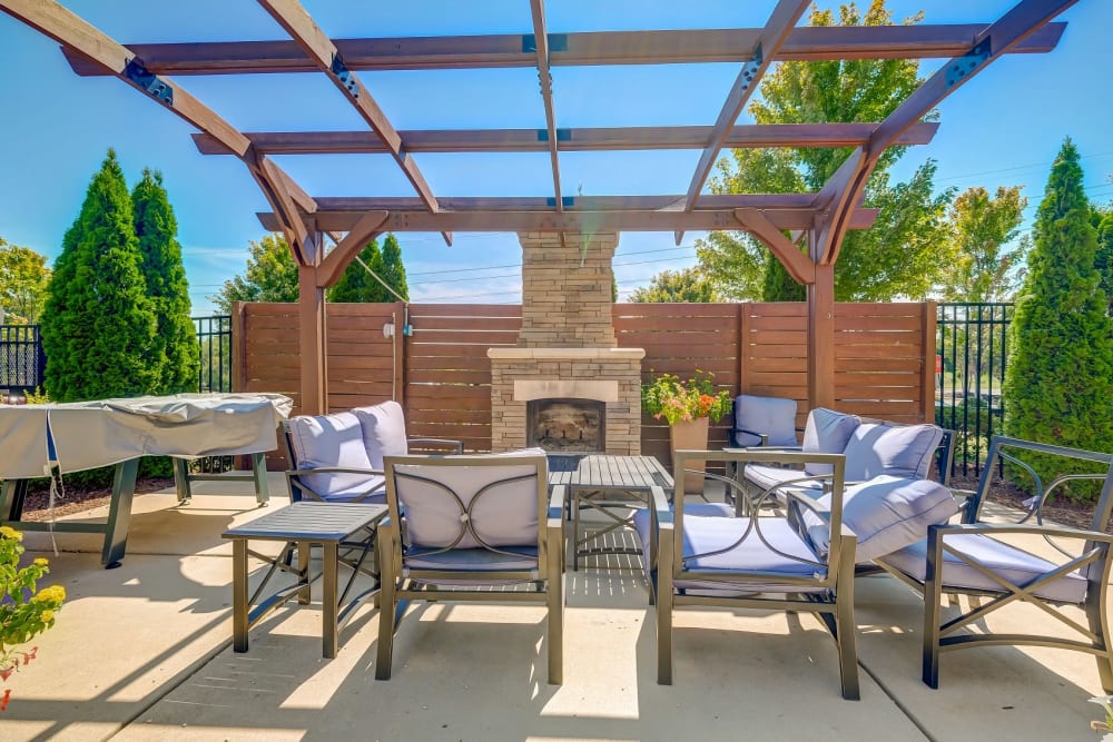Outdoor grilling space and fireplace at Reserve at Kenton Place Apartment Homes in Cornelius, North Carolina