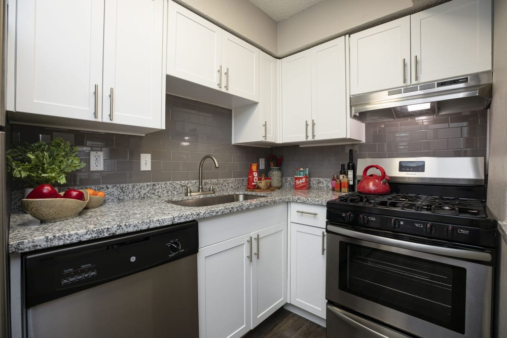 Kitchen with white cabinets at The Clara in San Antonio, Texas