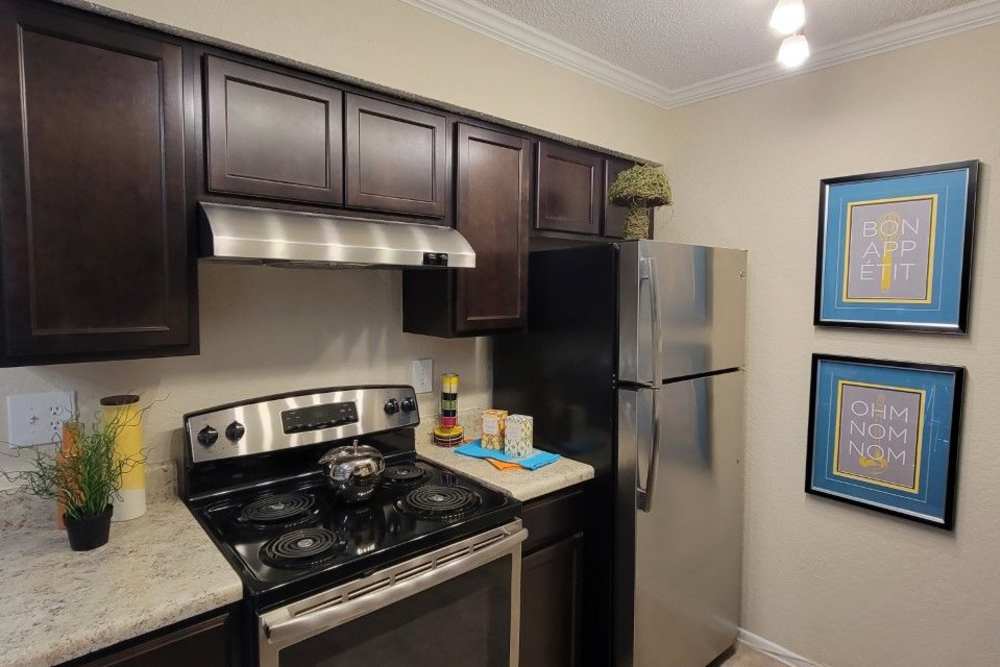 Kitchen with granite countertop and a refrigerator at The Abbey At Northlake in Riviera Beach, Florida