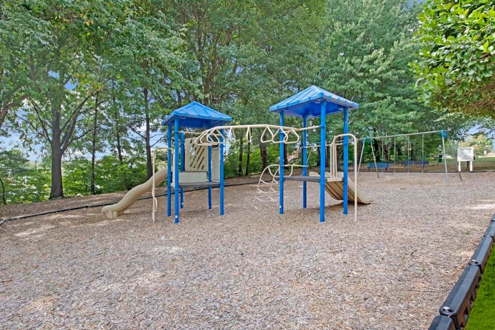 A children's playground with swings at Mill Creek Flats in Winston Salem, North Carolina