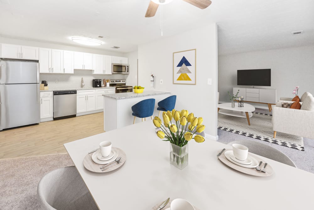 Kitchen with stainless steel appliances and staged dining room