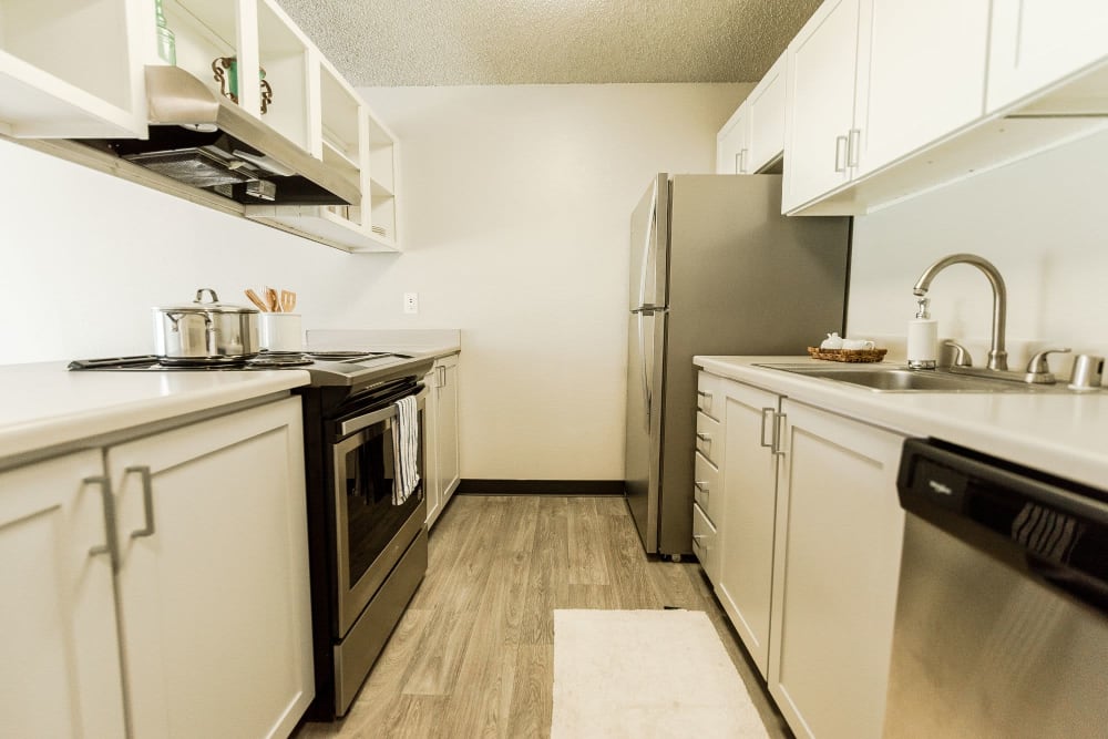 Model apartment kitchen with stainless steel appliances at Nova North in Everett, Washington