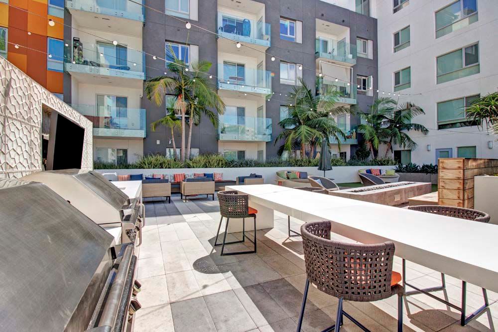 BBQ Area and long table at Apartments in Long Beach, California