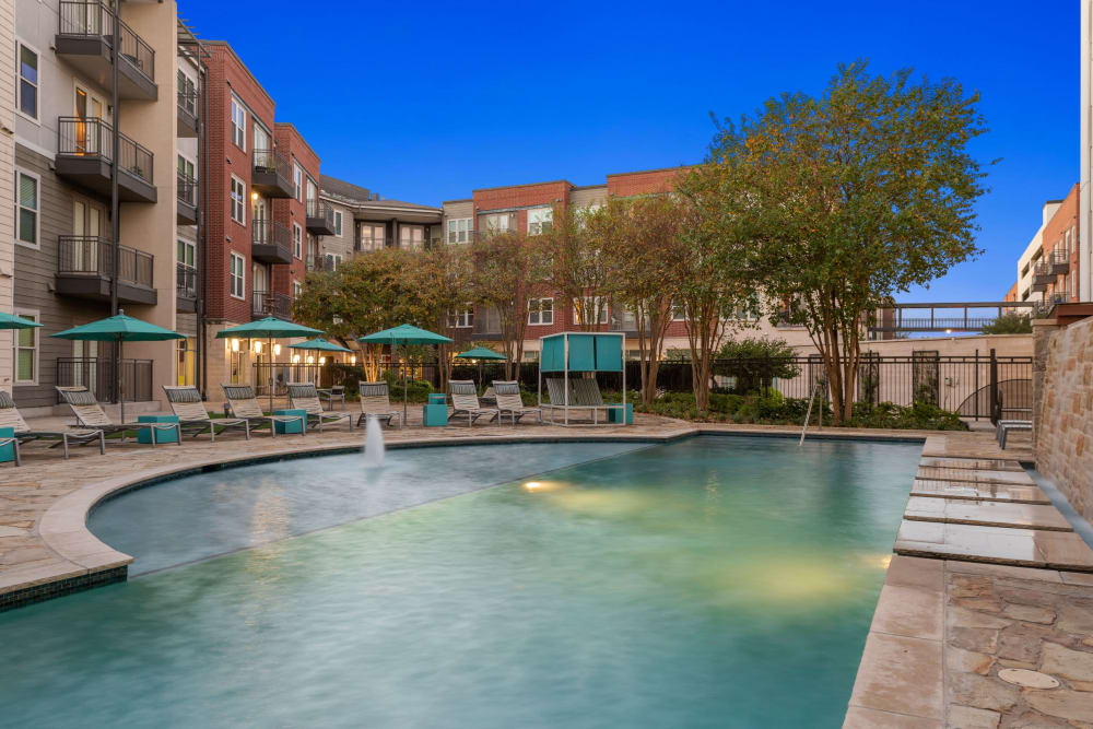 Early evening view of the swimming pool area at Union At Carrollton Square in Carrollton, Texas
