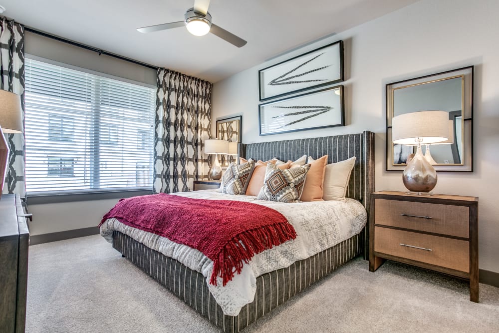 Beautifully decorated bedroom in a model home at Oro Stone Oak in San Antonio, Texas