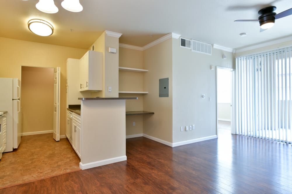 Living room and kitchen with wood flooring at Emerald Park Apartment Homes in Dublin, California