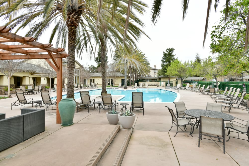 Poolside deck seating at Emerald Park Apartment Homes in Dublin, California