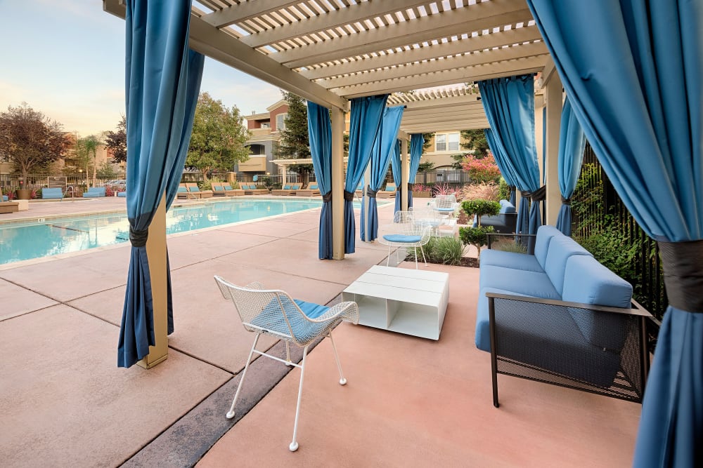 Covered seating by the pool at Avoca Dublin Station in Dublin, California