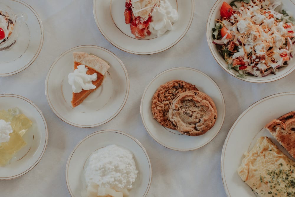 Large variety of foods plated on a table at The Whitcomb Senior Living Tower in St. Joseph, Michigan