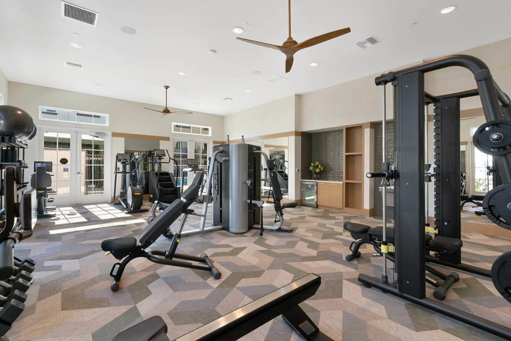 Weightlifting equipment in the fitness center at Alivia Townhomes in Whittier, California