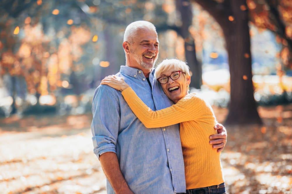 Couple smiling and posing together at The Whitcomb Senior Living Tower in St. Joseph, Michigan