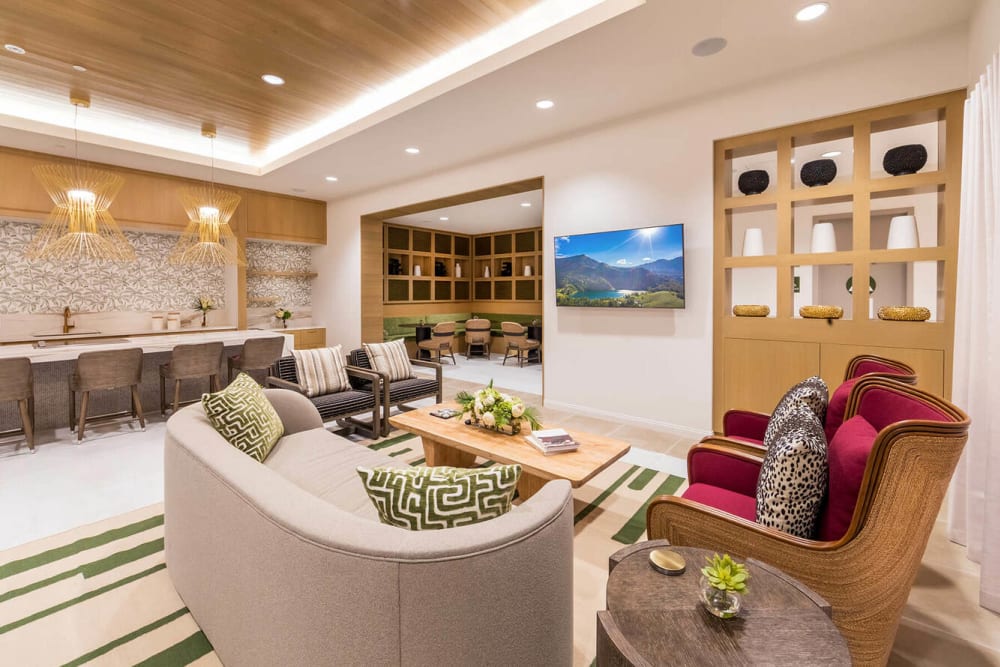 A couch in front of a TV in the resident lounge at Alivia Townhomes in Whittier, California