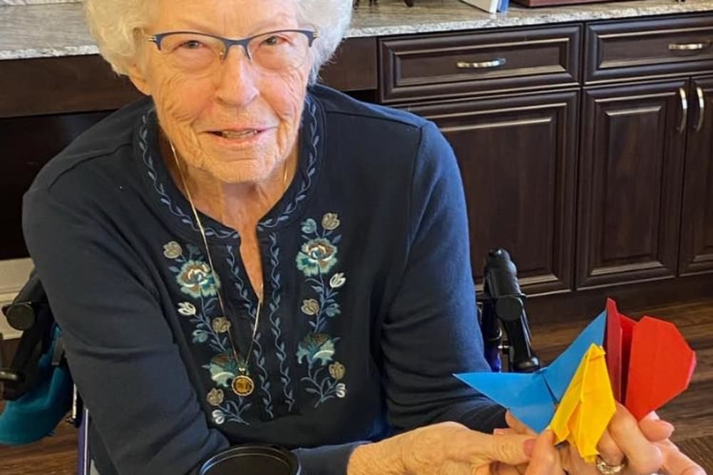 Resident showing some origami at Harmony Senior Services