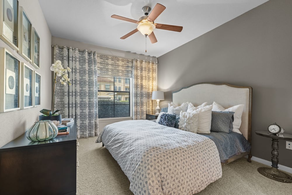 Carpeted bedroom with window at Marquis at the Reserve in Katy, Texas