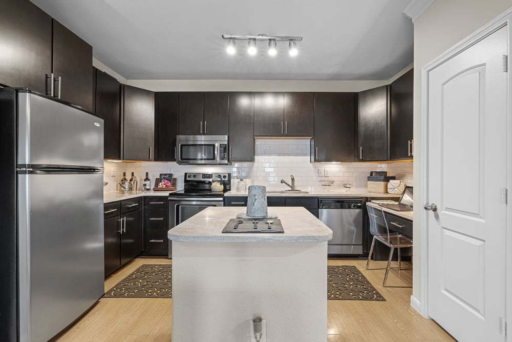 Modern kitchen with a build in desk at Marquis at the Reserve in Katy, Texas