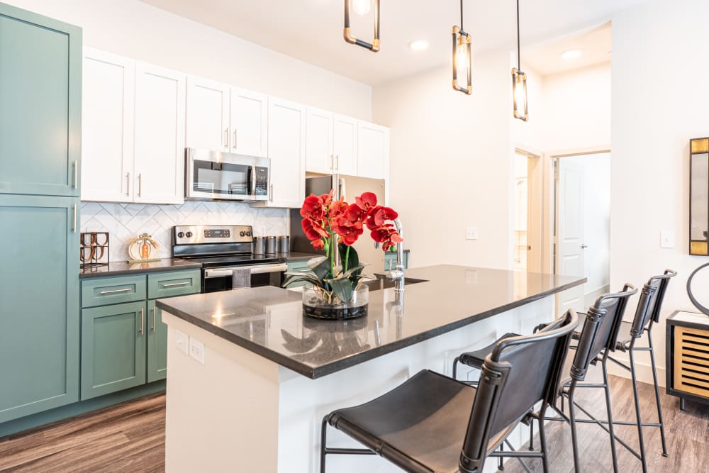 Kitchen with bar seating at The Everett at Ally Village in Midland, Texas