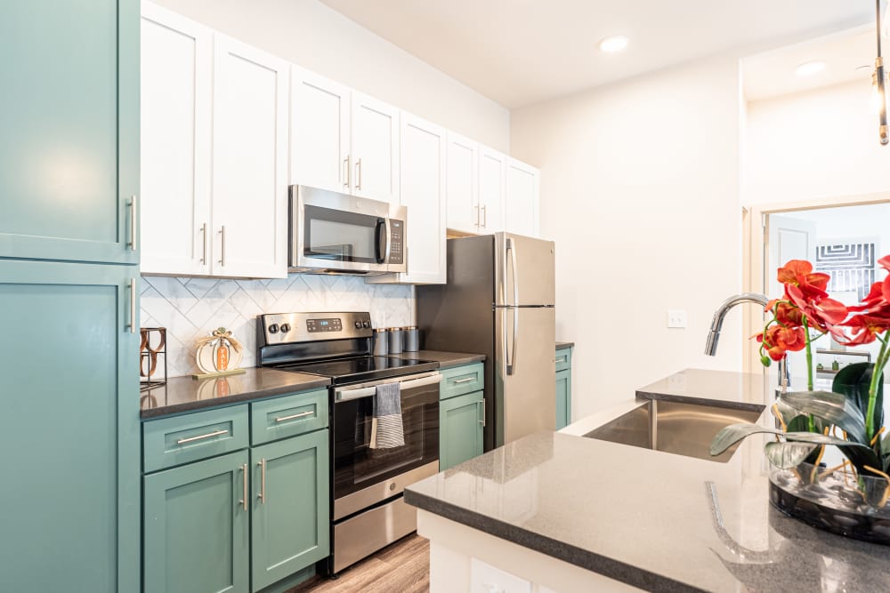 Kitchen with blue accents at The Everett at Ally Village in Midland, Texas