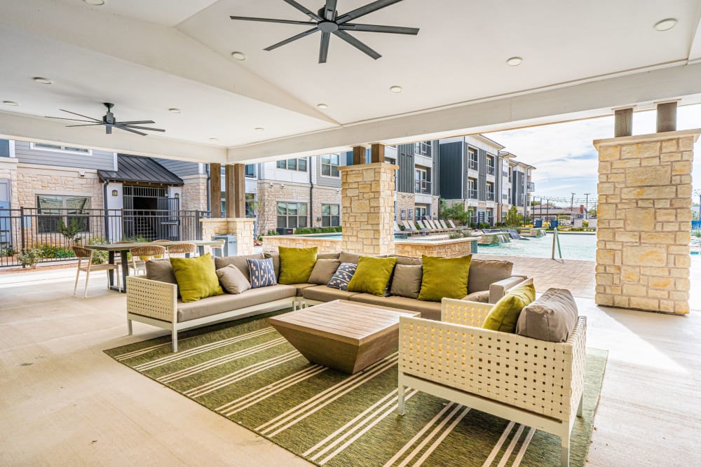 Seating area poolside at The Everett at Ally Village in Midland, Texas
